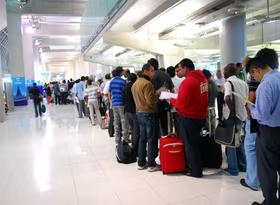 Line of people queueing at an airport