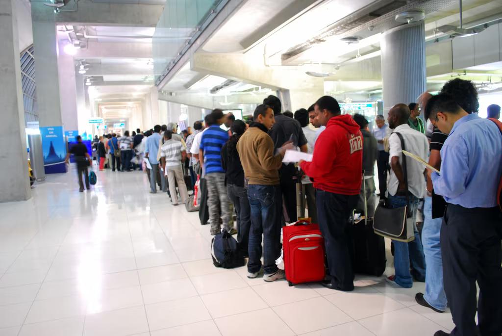 Line of people queueing at an airport