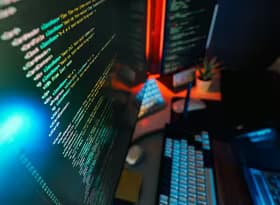 Futuristic Workspace with Coding on Monitor