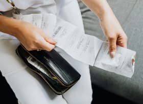 A person holding a wallet